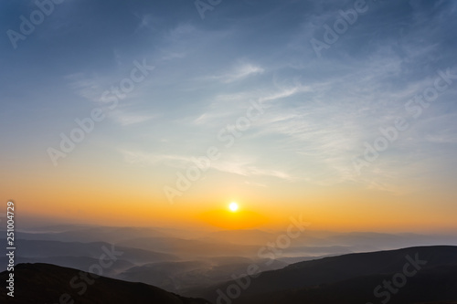 beautiful mountain valley in a mist at the sunrise, early morning mountain landscape © Yuriy Kulik