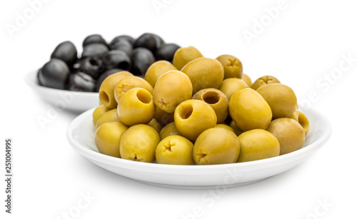 Saucers with black and green olives on white.