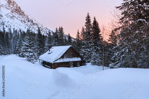 The old wooden house in mountains at dawn © castenoid