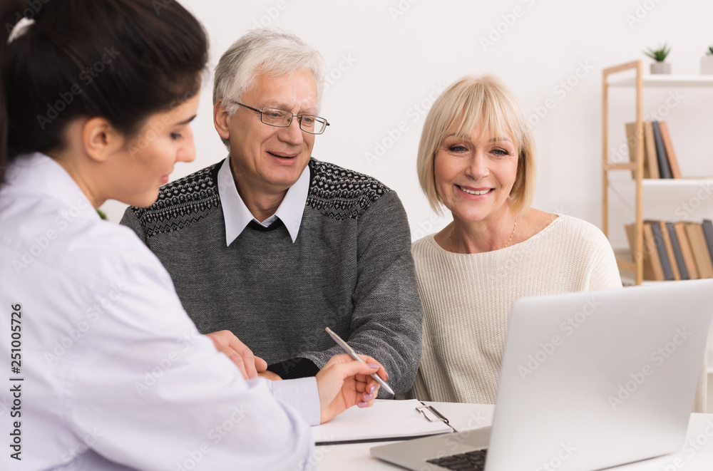 Happy senior couple discussing treatment plan with doctor Happy senior couple discussing treatment plan with doctor