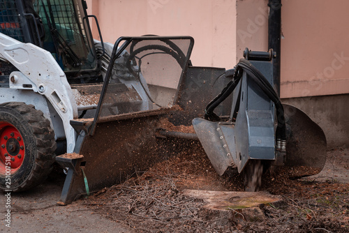 working mobile machine for cutting wood tree stump, tree stump removal