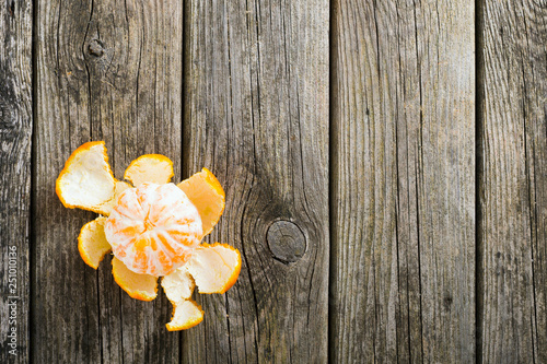 peeled tangerine on old wood table