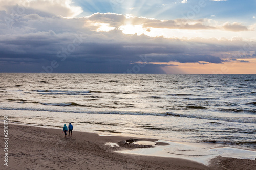 Couple walking along the beach at the polish seaside