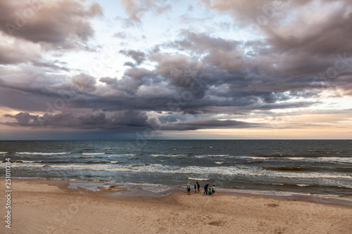 People on the beach, sunset over polish sea baltic