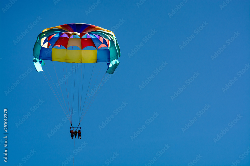 Sea and beach sport for tourists, parasailing in blue sky Sea and beach sport for tourists, parasailing in blue sky