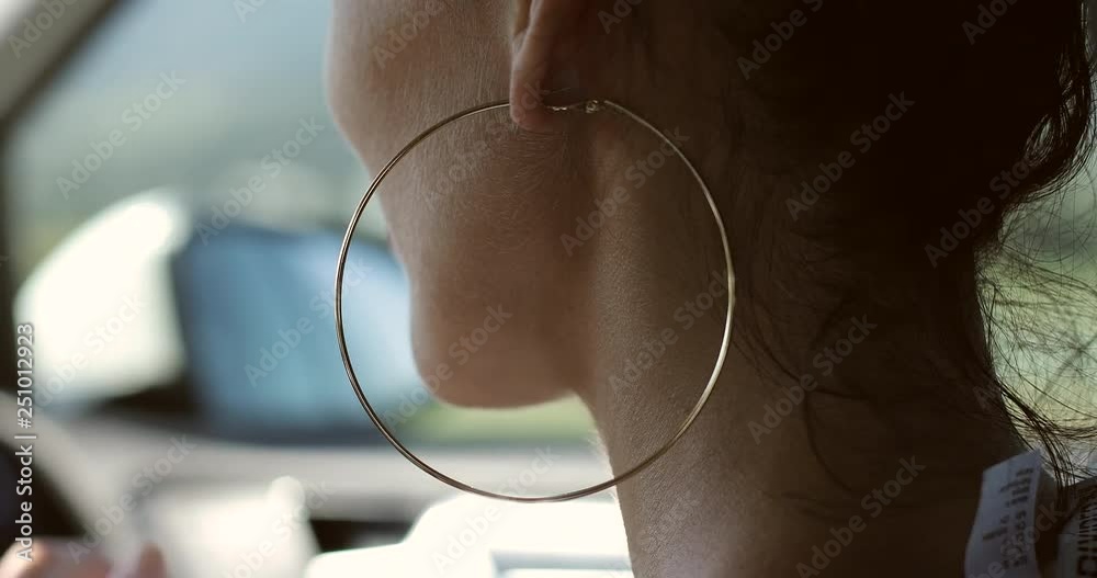 Close-up of brunette's neck with big earring.