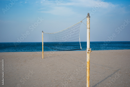 Beach volleyball net stands on a off-season beach