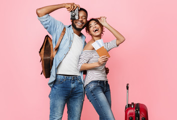 Ready for vacation. Happy couple with suitcase and tickets