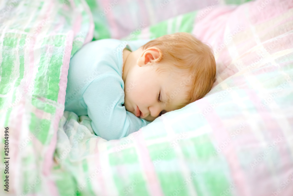 Adorable little baby girl sleeping in bed. Calm peaceful child dreaming during day sleep. Beautiful baby in parents bed. Sleeping together concept. Adorable little baby girl sleeping in bed. Calm peaceful child dreaming during day sleep. Beautiful baby in parents bed. Sleeping together concept.
