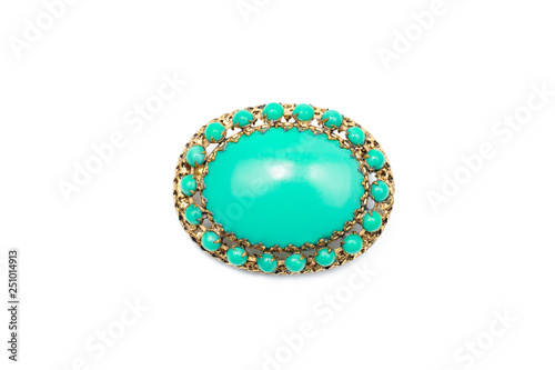 Vintage brooch green with gold on an isolated background