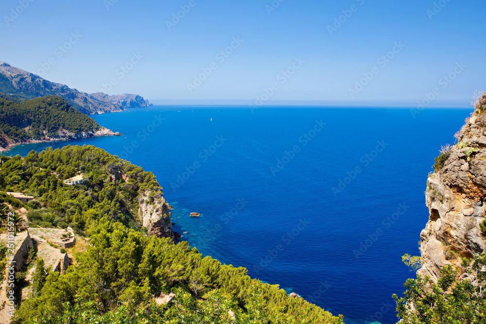 Island scenery, seascape of Mallorca Spain. Idyllic coastline of Majorca, Mediterranean Sea on sunny day. Turquoise water and green hills of Serra de Tramuntana.
