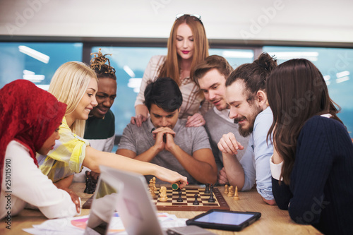 multiethnic group of business people playing chess