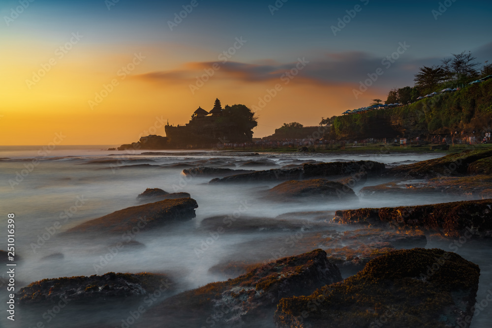 Sunset view of tanah lot temple on Sea in Bali Island. one of most famous tourist attraction in Indonesia.