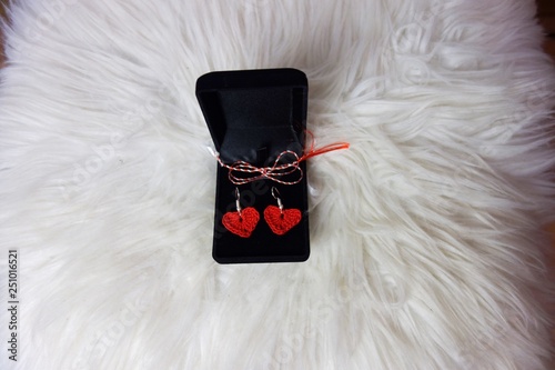 red crochet earrings heart shaped in a black velvet box