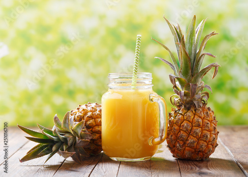 glass jar of pineapple juice with fresh fruits