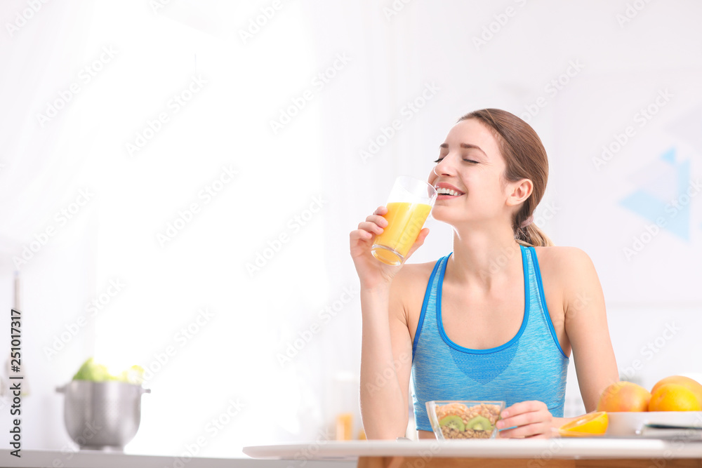 Young woman in fitness clothes having healthy breakfast at home. Space for text Young woman in fitness clothes having healthy breakfast at home. Space for text