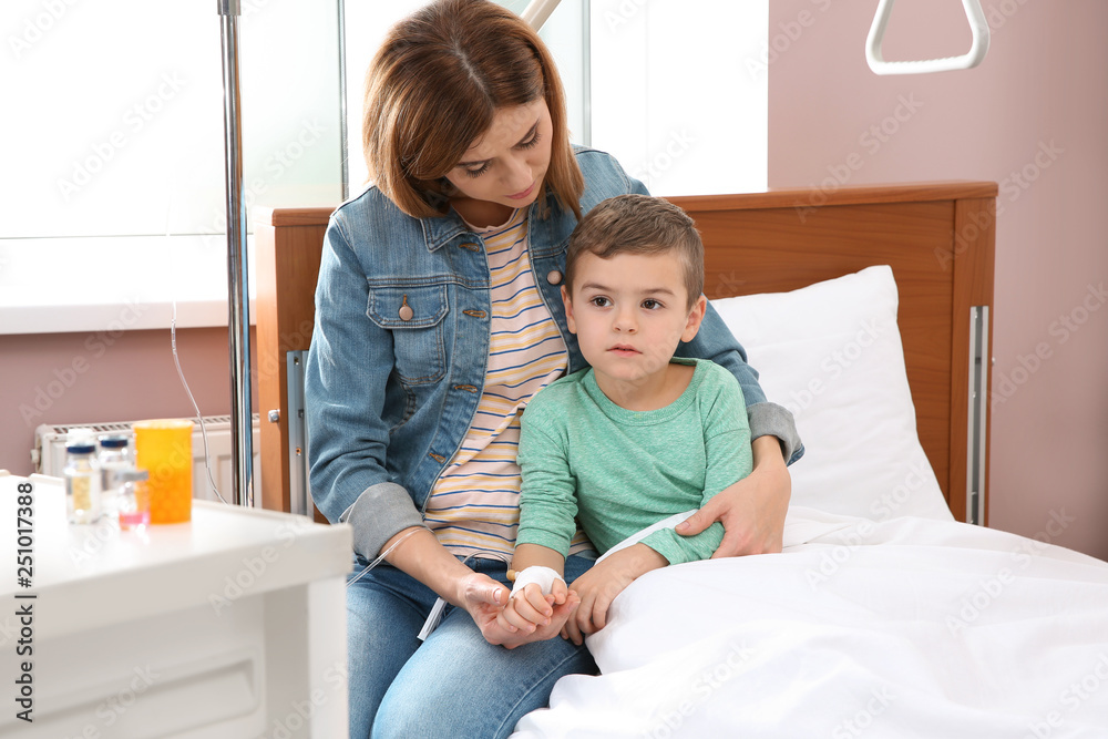 Woman visiting her little child with intravenous drip in hospital Woman visiting her little child with intravenous drip in hospital