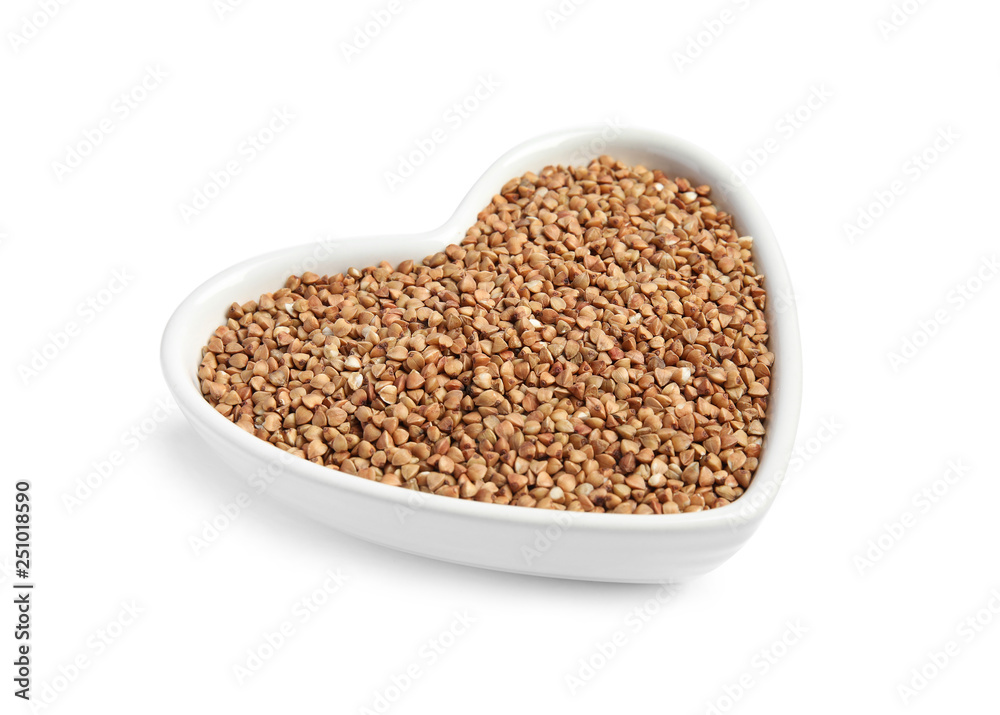 Bowl with uncooked buckwheat on white background Bowl with uncooked buckwheat on white background