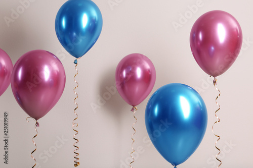 Color balloons with ribbons on white background