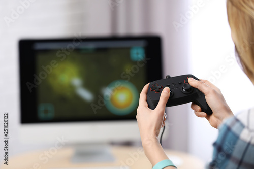 Young woman playing video game at home, closeup