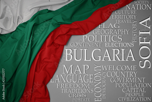 waving colorful national flag of bulgaria on a gray background with important words about country