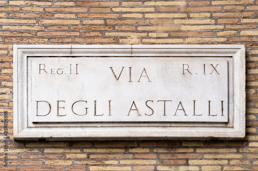 Via degli Astalli marble street sign in Rome on exterior wall Via degli Astalli marble street sign in Rome on exterior wall