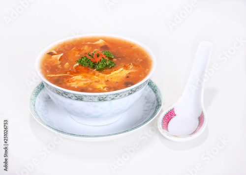 Traditional Chinese soup with typical Chinese / Asian dishes and spoon