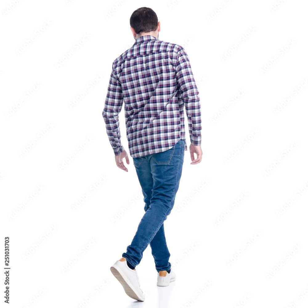 Fototapeta premium A man in jeans shirt goes walking on a white background. Isolation, back view