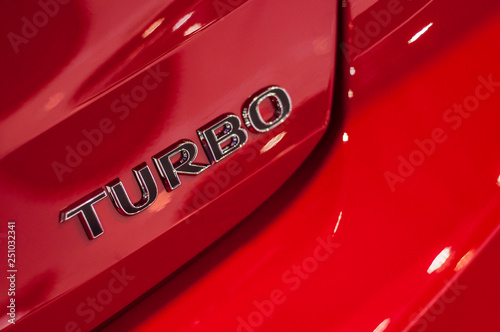 closeup of turbo sign on red car © pixarno