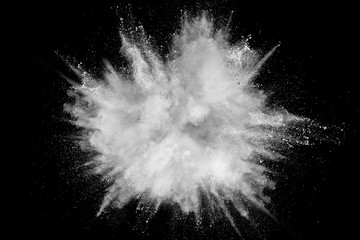 White powder explosion isolated on black background. White dust particles splash.Color Holi Festival.