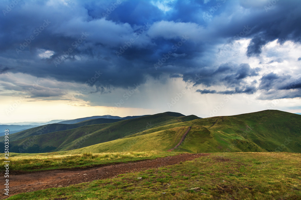 Summer in the Carpathian massif of Swidovets, located in Ukraine, with a lot of lakes, green pasture for sheep and horses, and wonderful, after a stormy sky with a rainbow.