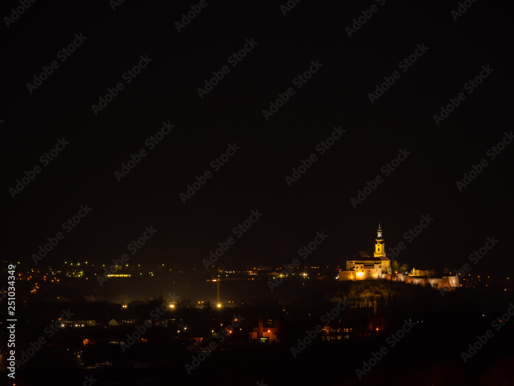 Fototapeta premium Full moon over the city. Full moon over Nitra city. Dark sky and full moon.