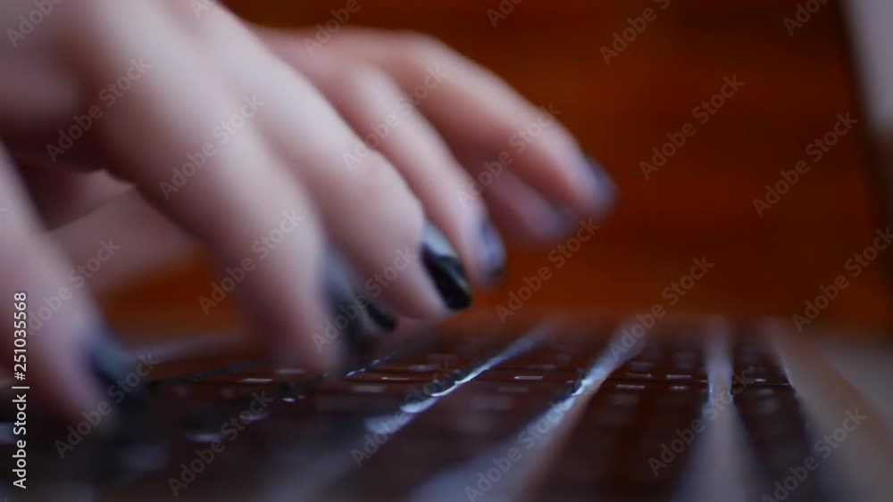 Beautiful fingers computer typing on a backlit laptop keyboard Beautiful fingers computer typing on a backlit laptop keyboard