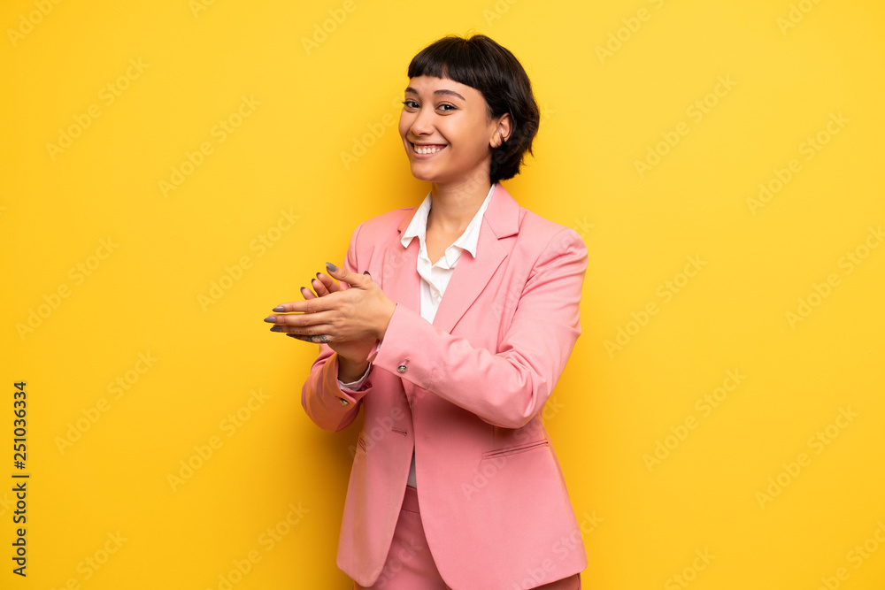 Modern woman with pink business suit applauding after presentation in a conference Modern woman with pink business suit applauding after presentation in a conference