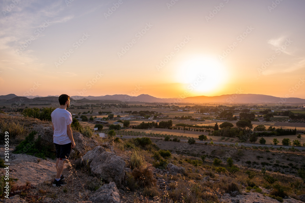 Man watching the sunset in a mountain