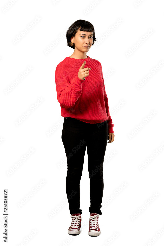 Fototapeta premium A full-length shot of a Short hair girl with red sweater frustrated and pointing to the front over isolated white background