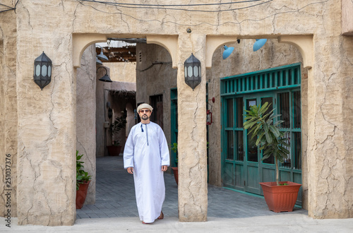 Arab Man walking in old Al Seef area of Dubai © katiekk2