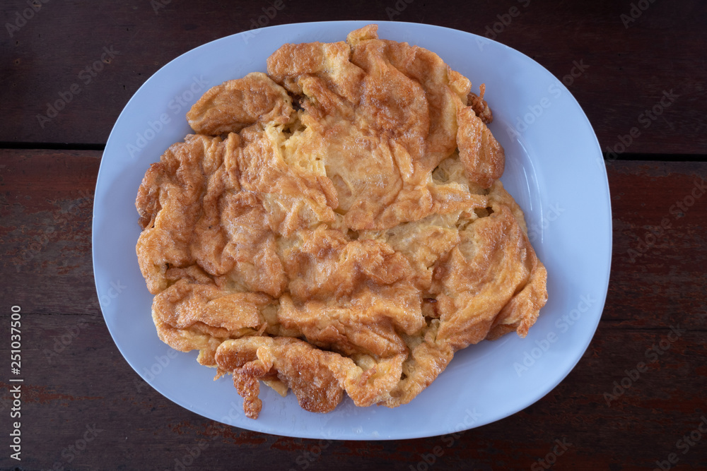 Delicious omelette on blue plate., Thai style omelette. Delicious omelette on blue plate., Thai style omelette.