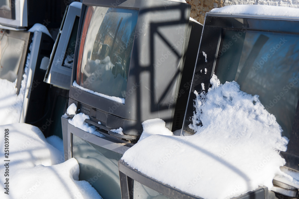 dump of old TVs covered with snow Stock Photo Adobe Stock