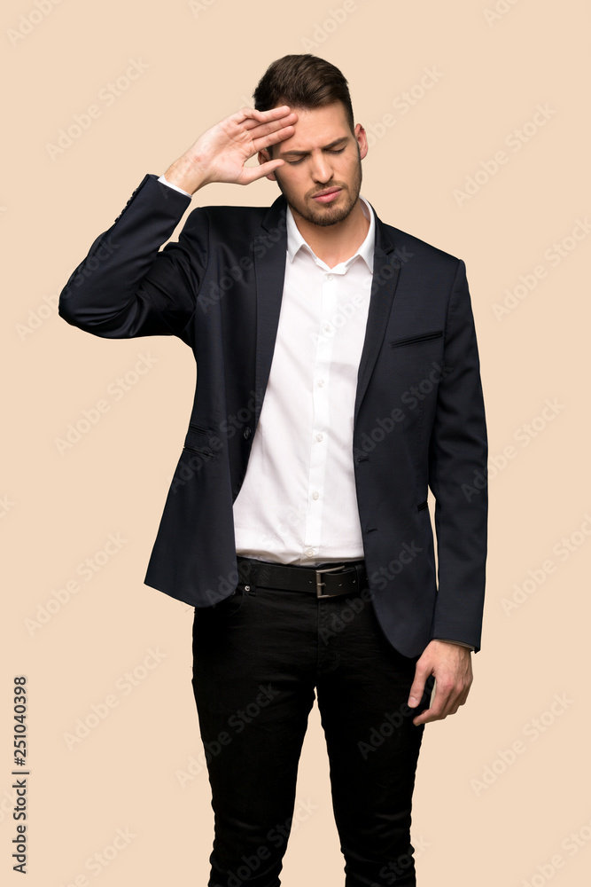 Handsome business man with tired and sick expression over ocher background Handsome business man with tired and sick expression over ocher background