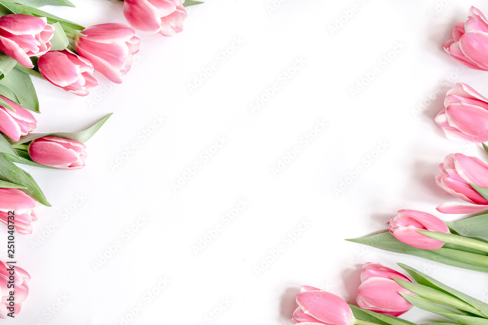 The composition of flowers. Frame made of pink tulips flowers on a white background. Flat lay, top view, copy space The composition of flowers. Frame made of pink tulips flowers on a white background. Flat lay, top view, copy space