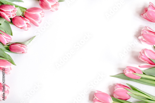 The composition of flowers. Frame made of pink tulips flowers on a white background. Flat lay, top view, copy space © Vall_Ben