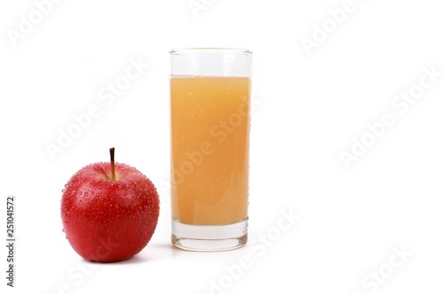 apple juice - ​red apple with drops of water and a glass of naturally cloudy apple juice in front of white background