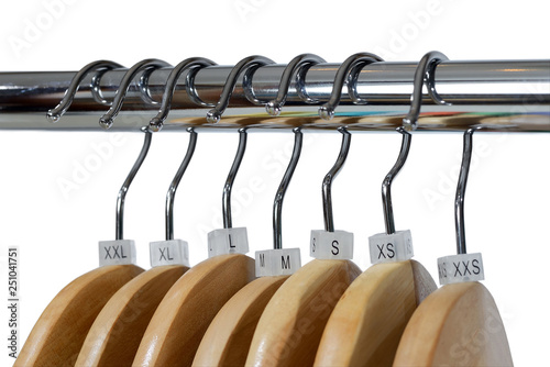 Wooden hangers with sizes tags isolated on white background.