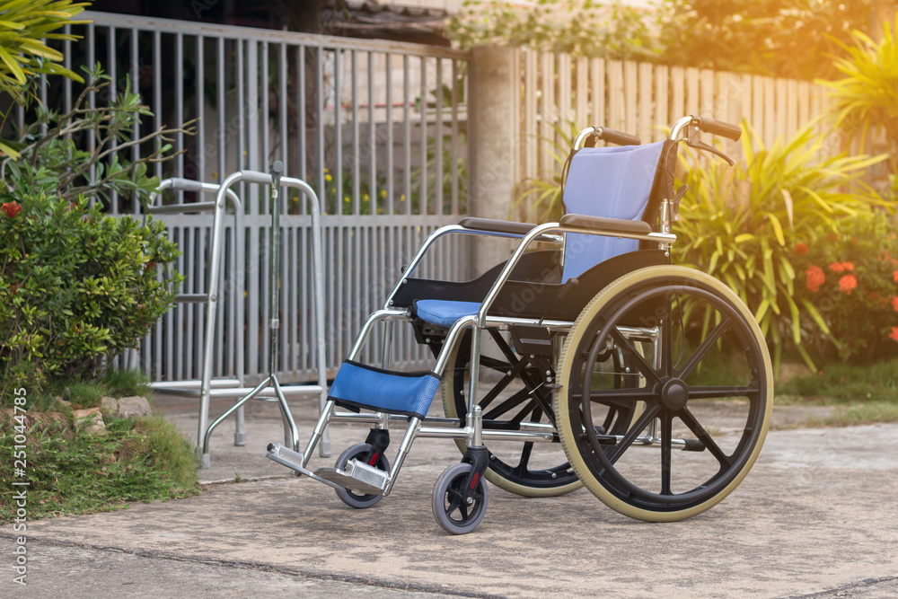 Empty wheelchair for patient or senior or elderly people at the front house,healthy medical concept
