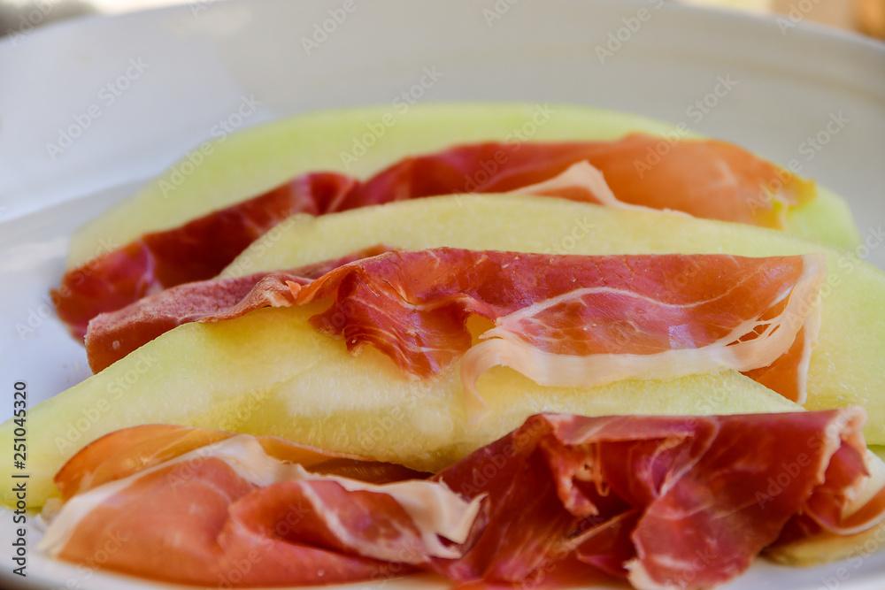  traditional Italian appetizer of prosciutto and melon. selective focus and copy space