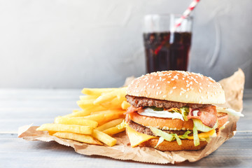 double cheeseburger with fries. takeaway lunch, fast food restaurant, fast food menu. light background, selective focus and copy space