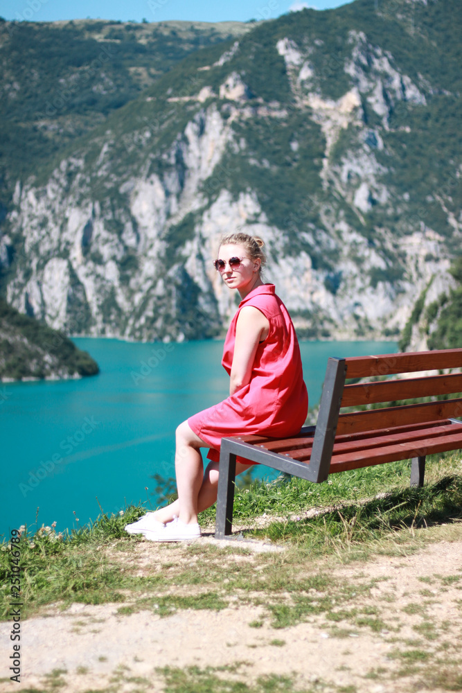 young woman sits in the mountains young woman sits in the mountains