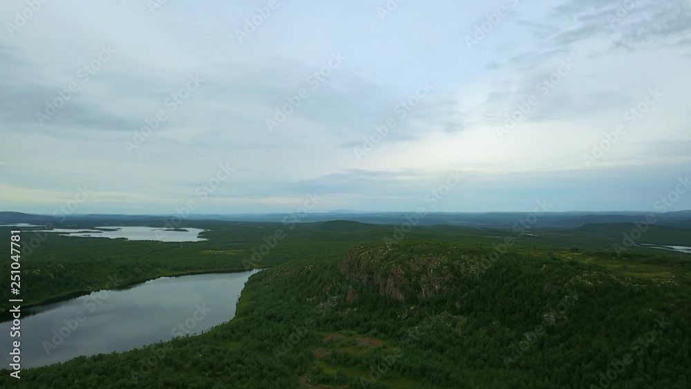 Top view of lake with stones and very green shores Top view of lake with stones and very green shores