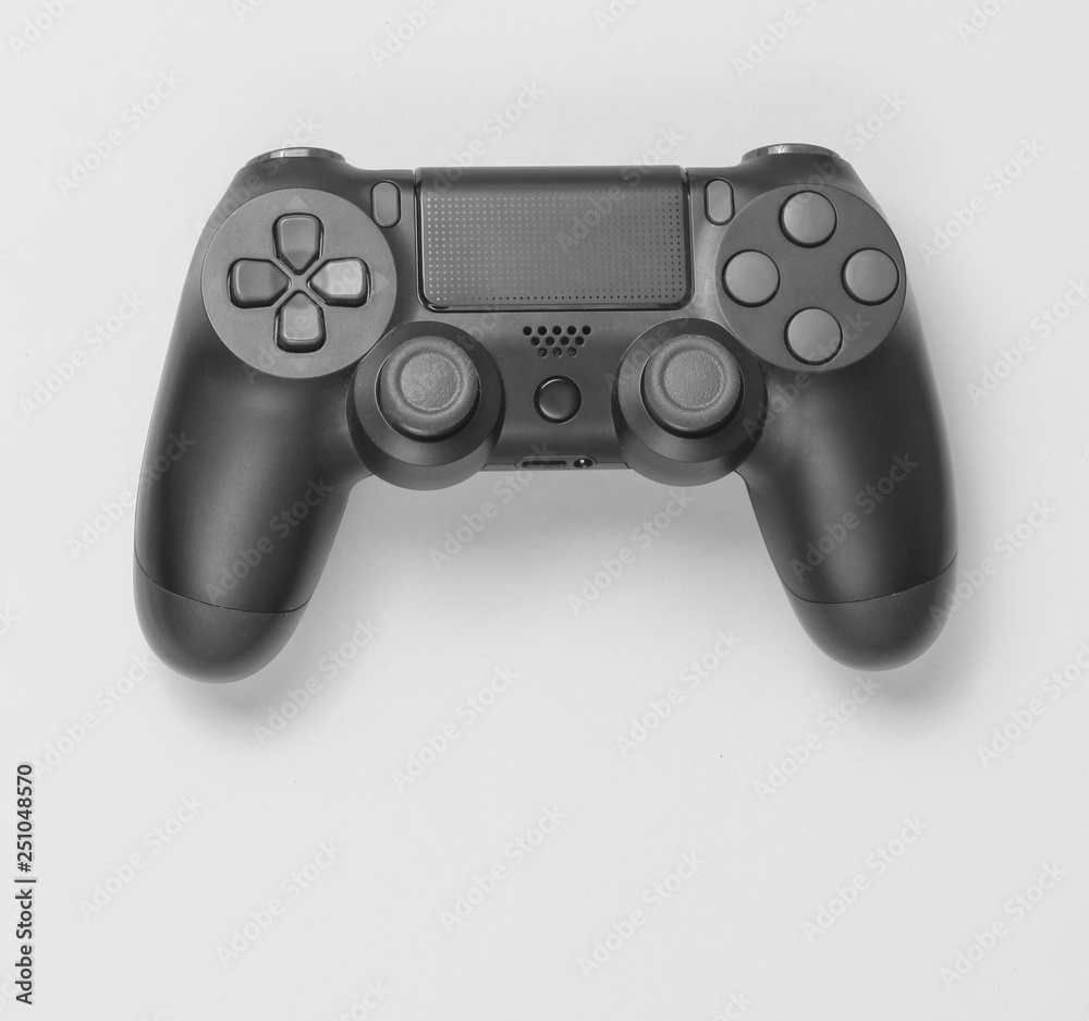 Gamepads on grayl paper background. Top view. Minimalism. Gamepads on grayl paper background. Top view. Minimalism.